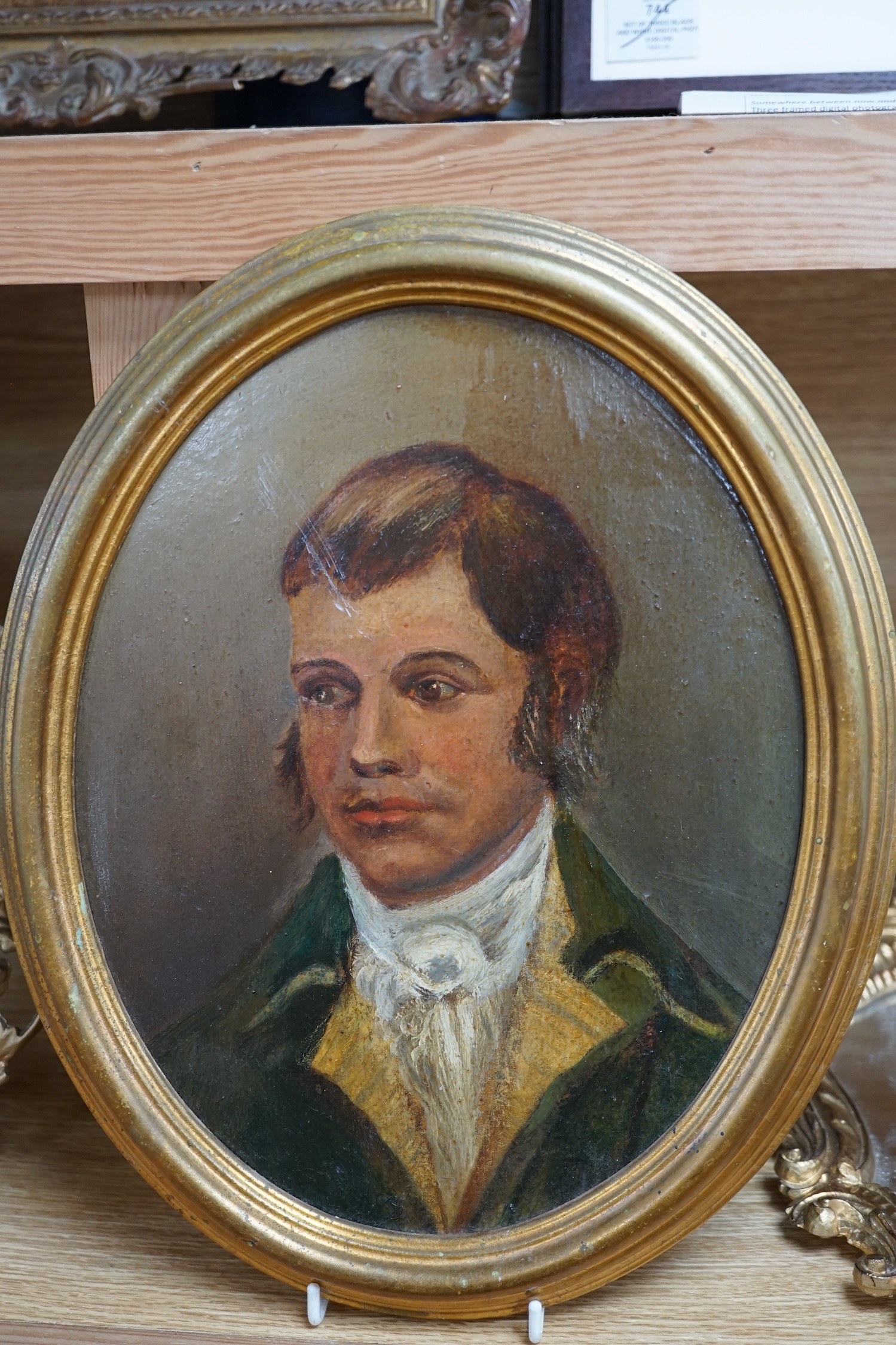 Early 19th century, oval oil on board, Portrait of a gentleman, together with another portrait of a lady, housed in a gilt metal frame, and an Italian rococo style gilt framed wall mirror, largest 28 x 22cm. Condition -